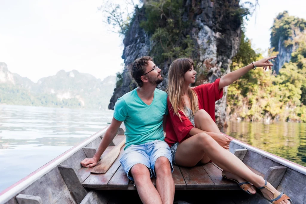 A couple taking a boat ride in the pristine waters of Palawan, one of the best wedding and honeymoon destinations in the Philippines.