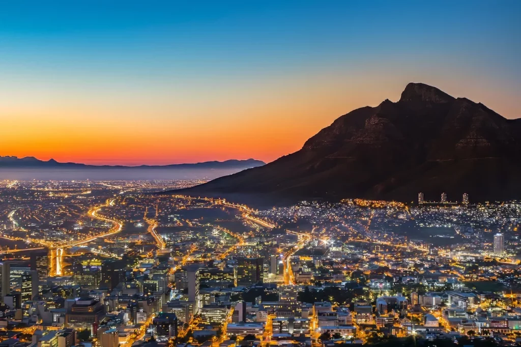 View of Table Mountain and Cape Town at sunrise -- attractions featured in this South Africa travel guide.