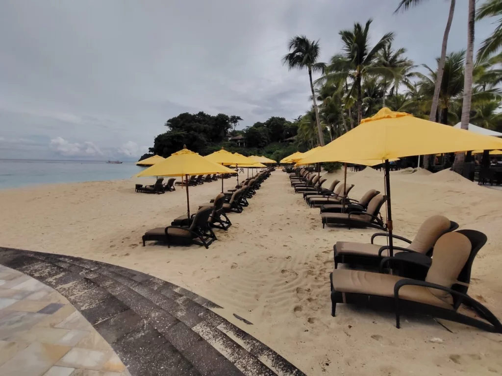 Shangri-La Boracay | Yellow umbrellas on the private beach.