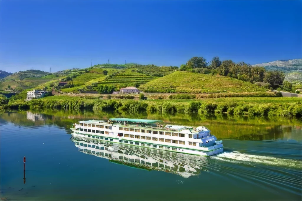 A cruise ship sailing off Douro Valley, one of Portugal's top honeymoon destinations.
